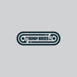 Logo badge reading 'RINK BROS' in bold, rounded font inside a dark teal rounded rectangle, with decorative gear-like elements around the text
